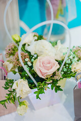 A bouquet of delicate flowers in a box. A convenient and beautiful flower arrangement for a gift.