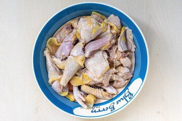 Fresh raw chicken meat on a melamine bowl, ready to be cooked. Top view.