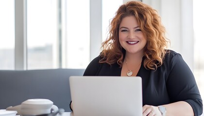 Smiling Redhead Woman Working on Laptop in Office