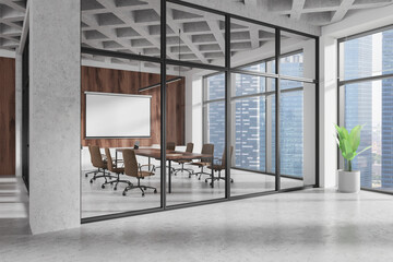 Meeting room interior with board and blank projection screen, panoramic window