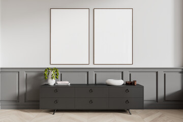 Two blank posters on a wall above a dark cabinet with various decor items. Modern interior design with light-colored wooden flooring and gray wainscoting. 3D Rendering