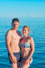 A couple on the background of the turquoise sea and mountains