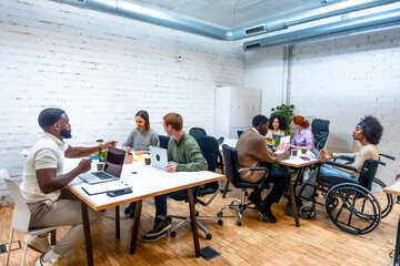 Diverse group of people working together in a modern coworking