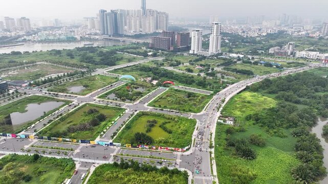 Three paraplanes flying above ho chi minh city with lush greenery and modern buildings, aerial view