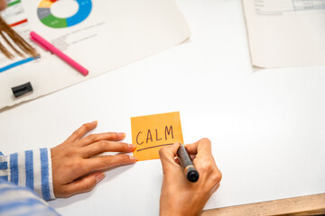 Hands of a woman writing notes on post-it