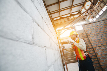 person hands hold hammer drill. Builder worker with pneumatic hammer drill perforator equipment...