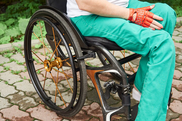 Close up of woman in green pants using wheelchair