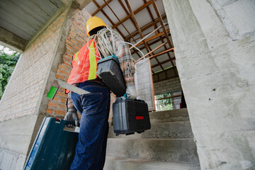 Worker with tool. Builder handyman with construction tools. House renovation background. Male worker with tool bag near door at home