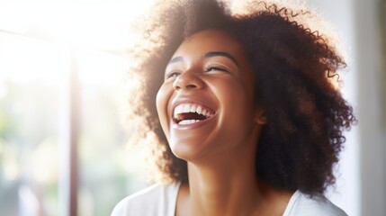 A young person laughs radiantly, their joyful expression captured in a moment of pure happiness, while illuminated by soft natural light.