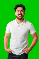 A smiling young man with a beard poses against a bright green background