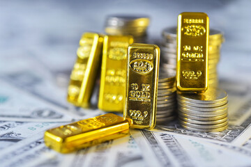 Gold bar lean against the stacking coins on  USD bills . Gold is hard commodity goods, risk asset, tangible value that used to be gold reserve, save assets during war and economic crisis