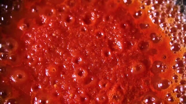 red tomato paste boiling macro view