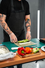 Preparing sushi rolls with fresh ingredients at a culinary studio