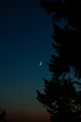 Crescent Moon, stars, planet conjunction and landscape scenery silhouettes.