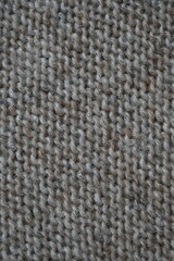  texture of knitted light brown sweater, close-up texture of beige knitted fabric, macro texture of tan knitted woolen clothes   