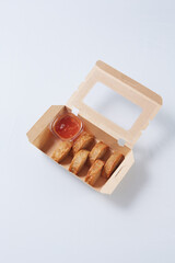 fried pork sausage from Vietnamese and sweet chili dip sauce in cardboard box isolated on white background