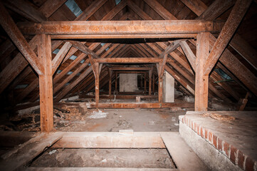 Rustic Abandonment: A Journey Through a Dusty Attic with Exposed Beams and Forgotten Treasures