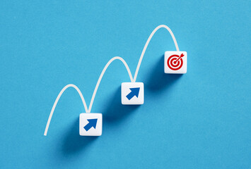Arrow signs leading to target on blue background, business concept