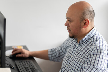Latin man using computer at work