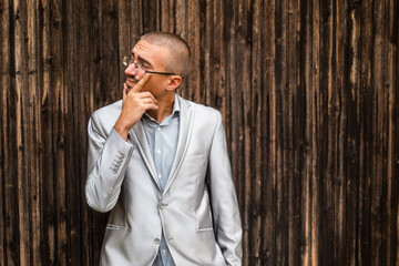 Portrait of thoughtful and worried businessman. Wooden background.