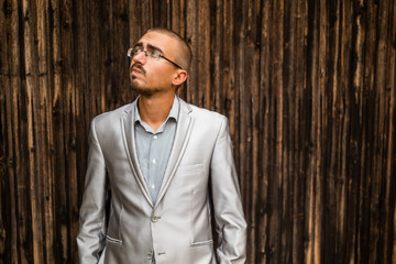 Portrait of thoughtful and worried businessman. Wooden background.