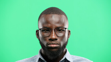 Man's face, close-up, on a green background