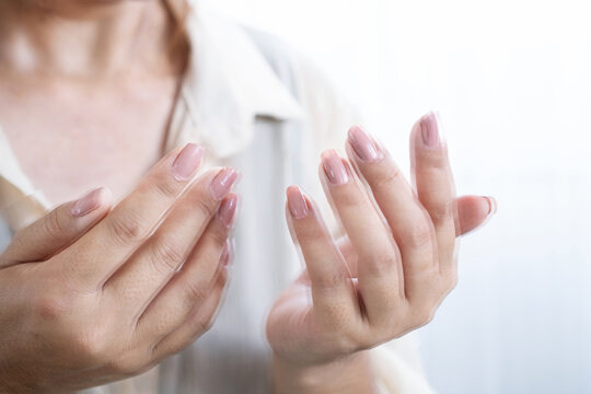 Woman suffering from essential tremor, hand shaking during movement,  can be used for  Parkinson's disease syndrome concept