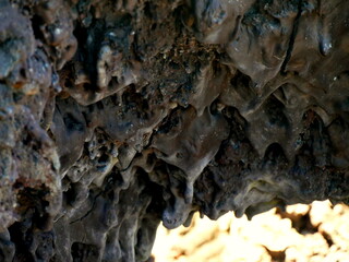 Chocolate like lava flows rock on Dolomieu crater, Fournaise volcano, Reunion island. Smooth surface of pahoehoe lava forming drop shaped rocks