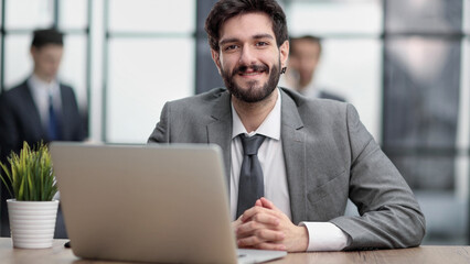 Fototapeta premium Thoughtful businessman pondering ideas or strategy, sitting at wooden with laptop,