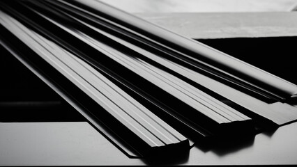 Metal siding for fence, roof, blinds, metal profile isolated on black background close-up © amixstudio