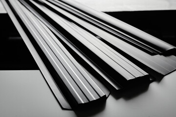 Metal siding for fence, roof, blinds, metal profile isolated on black background close-up