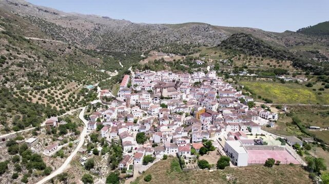 Breathtaking view of a village in Spain from the air, surrounded by greenery and historic buildings, Alpandeire, Malaga, Andalucia, Spain