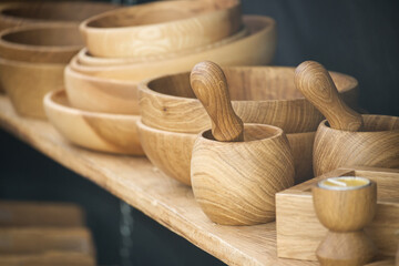 Handcrafted wooden bowls and mortars with pestles on display showcasing exquisite craftsmanship
