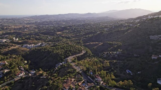 Spectacular aerial perspective of verdant rolling hills and valleys during the serene sunset, Costa del Sol, Malaga, Andalucia, Spain