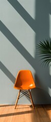 Stylish Orange Chair Against a Soft Blue Wall with Natural Light and Shadows