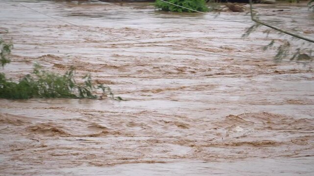 Transmission power lines are touching flood water heights in river.