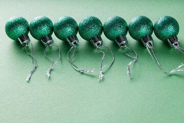 Christmas Balls with Glossy Green Glitter on Minimal Green Background, Copy Space