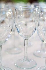 Lots of empty, clean glasses on the table.