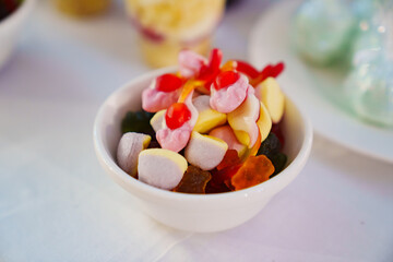 A small bowl with colorful gummies. 