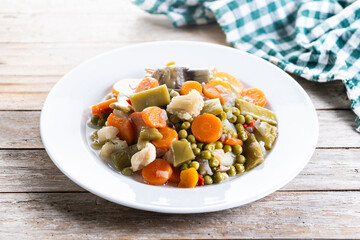 Vegetable stew (menestra de verduras) on wooden table