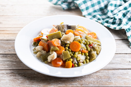 Vegetable stew (menestra de verduras) on wooden table