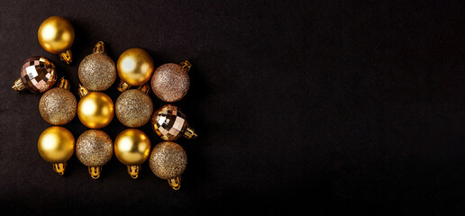 Golden and shiny Christmas balls isolated on black background with clipping path for holiday banner design, greeting card and Christmas gift decoration