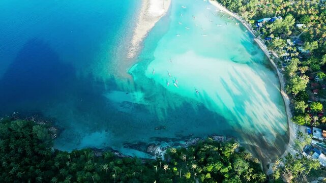 Clear water beach in tropical Koh Pha-ngan Thailand's pristine sea shore Aerial Drone View