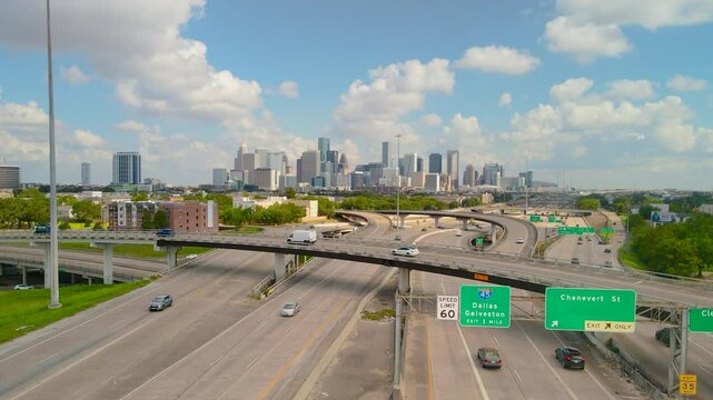 Aerial Establishing Downtown Houston Texas, skyline Traffic Skyscraper buildings Texas 288 freeway. Drone shoot the Texas 288 overlooking Houston Downtown. Intersection Texas 288 and I45 Freeway.