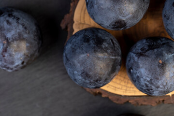 Obraz premium ripe purple plum on the table