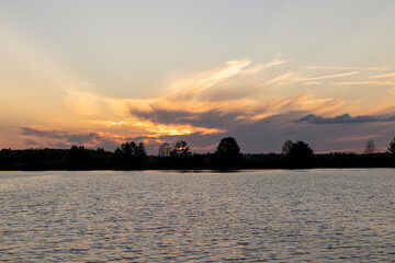 beautiful bright sunset on the lake in the summer