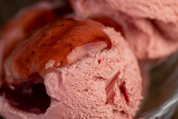 red strawberry-flavored ice cream in a glass bowl