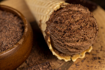 chocolate ice cream in a cone on a board
