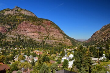 looking down on the historic mining town of ouray in the san juan mountains of colorado on a sunny fall day, from the start of the million dollar highway