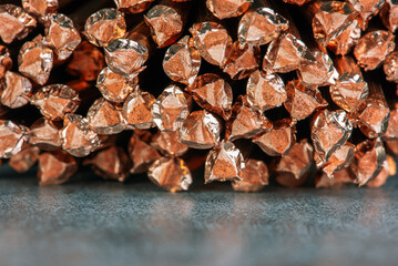 Copper wire scrap on metallic surface, in a non-ferrous metal recycling factory, a raw material for reuse